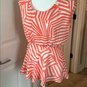 Coral and white blouse with cutout back.